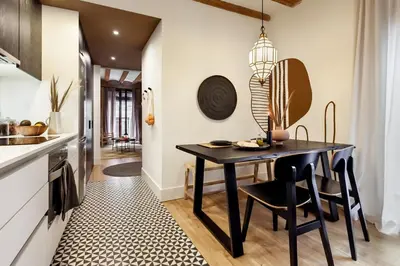 a dining room with a black table and chairs at Annamer - 2 bedrooms and terrace in El Born in Barcelona