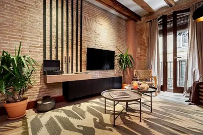 a living room with a couch and a table at Annamer - 2 bedrooms and terrace in El Born in Barcelona