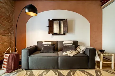 a living room with a brick wall and a tv at Annamer - 2 bedrooms and terrace in El Born in Barcelona