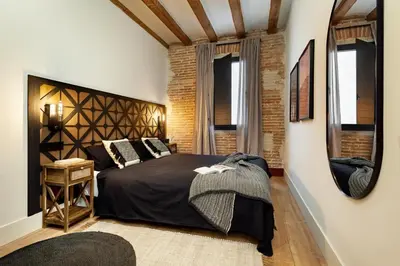 a bedroom with a large bed and a mirror at Annamer - 2 bedrooms and terrace in El Born in Barcelona