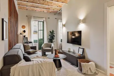 a white kitchen with a washer and dryer at Paleo - 2 bedrooms and office in Eixample Dreta in Barcelona