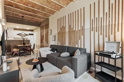 a living room with a couch and a table at Paleo - 2 bedrooms and office in Eixample Dreta in Barcelona