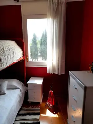 a bedroom with a bed and a window at Canet playa in Canet de Mar