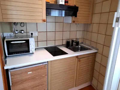 a small kitchen with a sink and a microwave at Canet playa in Canet de Mar