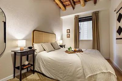 a kitchen with stainless steel appliances and a dining room at Faya - 1 bedroom and balcony in Gràcia in Barcelona