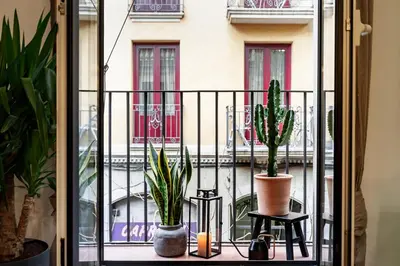 a balcony with potted plants and a window at Faya - 1 bedroom and balcony in Gràcia in Barcelona