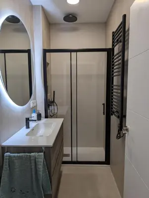 a bathroom with a sink and a shower with a mirror at Cal Ticó, 6 guests Monistrol de Montserrat in Monistrol
