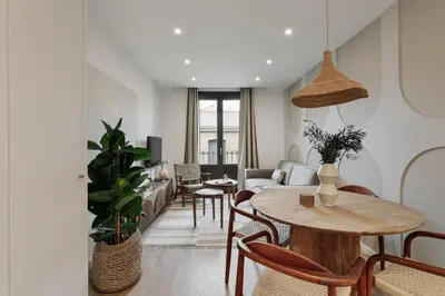 a living room with a couch and a table at Piano - 2 bedrooms and terrace in Ciutat Vella in Barcelona