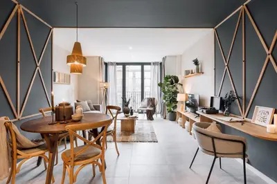 a living room with a table and chairs at Vacar - 3 bedrooms in Eixample Esquerra in Barcelona