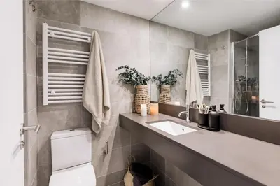 a living room with a tv and a desk with a chair at Vacar - 3 bedrooms in Eixample Esquerra in Barcelona