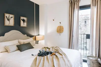 a bedroom with a bed and a mirror at Vacar - 3 bedrooms in Eixample Esquerra in Barcelona