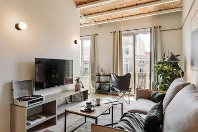 a living room with a table and chairs at Rothko - 2 bedrooms and office in Eixample Dreta in Barcelona