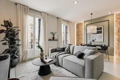 a living room with a brick wall and a mirror at Judd - 3 bedrooms and balcony in Eixample Esquerra in Barcelona