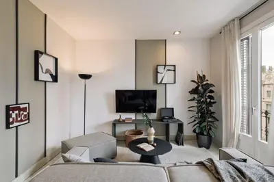 a bedroom with a large white bed with two lamps at Judd - 3 bedrooms and balcony in Eixample Esquerra in Barcelona