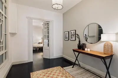a hallway with a table and a mirror at Valls - 2 bedrooms and office in Gràcia in Barcelona