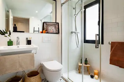 a bedroom with a large bed and white cabinets at Anfa - 2 bedrooms in El Born in Barcelona