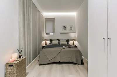 a bedroom with a large bed with a book on it at Grotta - 3 bedrooms in Sant Gervasi in Barcelona