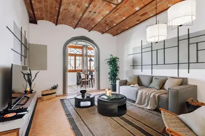 a living room with a couch and a table at Balai - 2 bedrooms in Eixample Dreta in Barcelona