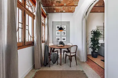 a kitchen with wooden cabinets and a black dishwasher at Balai - 2 bedrooms in Eixample Dreta in Barcelona