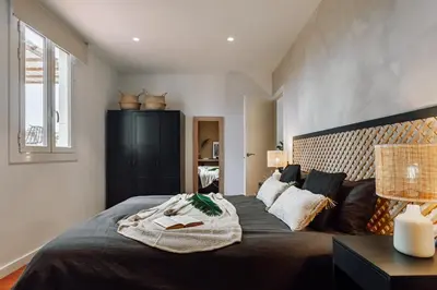 a bedroom with a large bed with a large headboard at Kambove - 2 bedrooms in Eixample Dreta in Barcelona