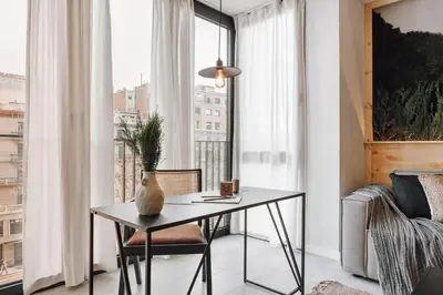 a bedroom with a large bed with a wooden headboard at Aneto - 3 bedrooms in Eixample Esquerra in Barcelona