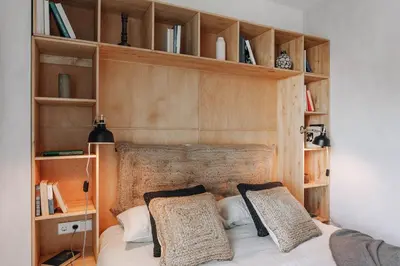 a bedroom with a bed with wooden shelves at Aneto - 3 bedrooms in Eixample Esquerra in Barcelona