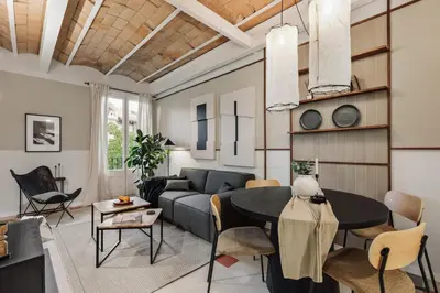 a living room with a couch and a table at Andy - 2 bedrooms and office and balcony in Eixample Dreta in Barcelona