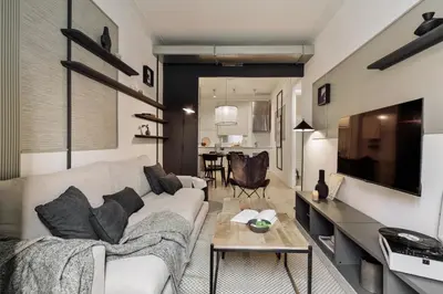 a living room with a white couch and black shelves at Warhol - 2 bedrooms and balcony in Sant Gervasy in Barcelona
