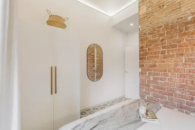 a living room with a couch and a television at Maiori - 2 bedrooms and terrace in Sant Gervasi in Barcelona