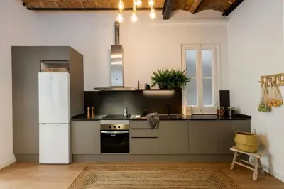 a dining room with a wooden table and shelves at Tambo - 2 bedrooms in Eixample Esquerra in Barcelona
