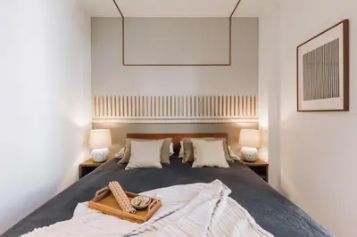 a hallway with white walls and a bedroom with a bed at Ohanes - 2 bedrooms in Eixample Esquerra in Barcelona