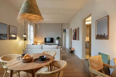 a living room with a table and a couch at Muari - 2 bedrooms in Eixample Esquerra in Barcelona