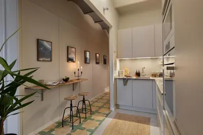 a living room with a white couch and a tv at Muari - 2 bedrooms in Eixample Esquerra in Barcelona