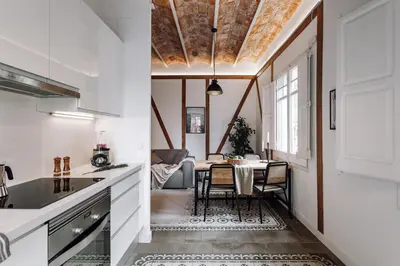 a dining room with a table and a couch at Ossau - 3 bedrooms in Sant Gervasi in Barcelona