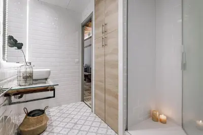a bedroom with a bed with a mirror and a table at Ossau - 3 bedrooms in Sant Gervasi in Barcelona