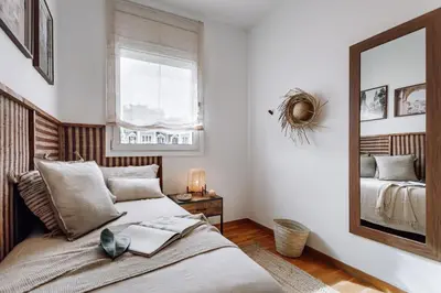 a living room with a table and chairs and a mirror at Cazalla - 2 bedrooms and office in Gràcia in Barcelona