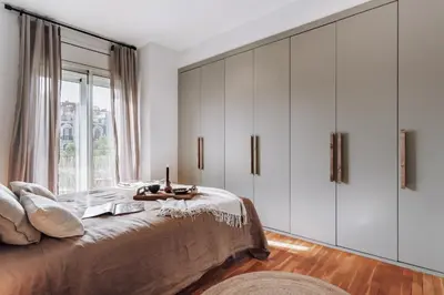 a bedroom with a bed with a window and a table at Cazalla - 2 bedrooms and office in Gràcia in Barcelona