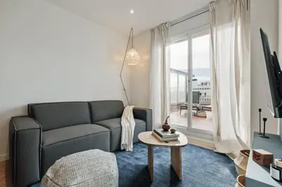 a living room with a table and a couch at Banchina - 1 bedroom and terrace in Sant Gervasi in Barcelona