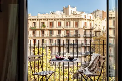 a black vase with white flowers on a table at Aino - 2 bedrooms and balcony in Eixample Esquerra in Barcelona
