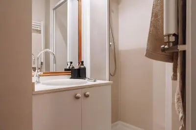 a brick wall in a living room with a picture at Nava - 3 bedrooms in Sant Gervasi in Barcelona
