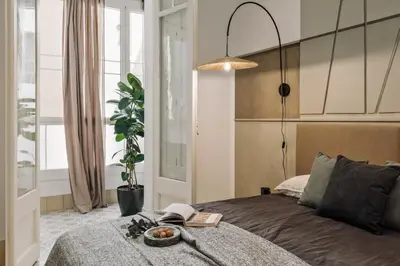 a hallway with white walls and a table and a mirror at Uru - 2 bedrooms and balcony in Vila de Gràcia in Barcelona