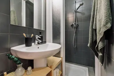 a bedroom with a bed and a potted plant at Uru - 2 bedrooms and balcony in Vila de Gràcia in Barcelona