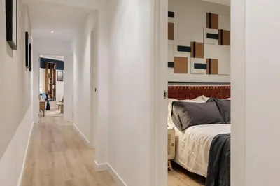 a living room with white cabinets and a table at Levent - 3 bedrooms and terrace in Sant Antoni in Barcelona