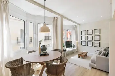 a living room with a table and chairs and a couch at Conca - 2 bedrooms apartment in Sant Gervasi in Barcelona