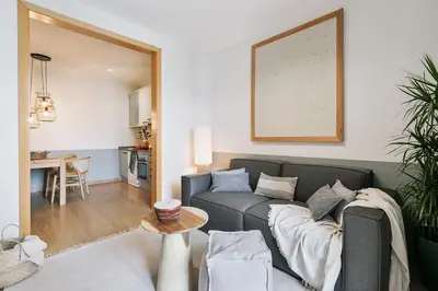 a living room with a couch and a framed picture at Furore - 1 bedroom in Eixample Esquerra in Barcelona