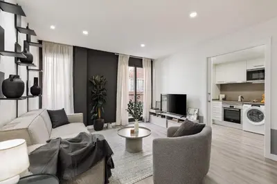a living room with a couch and a table at Heures - 2 bedroom, office and pool in Les Corts in Barcelona