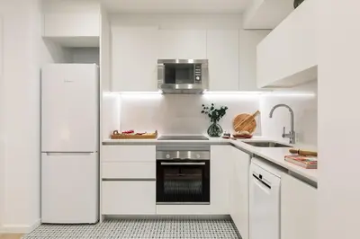 a living room with a couch and a tv at Cava - 2 bedrooms and terrace in Ciutat Vella in Barcelona