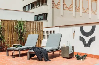 a patio with a couch and a table and chairs at Cava - 2 bedrooms and terrace in Ciutat Vella in Barcelona
