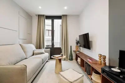 a living room with a couch and a table at Cava - 2 bedrooms and terrace in Ciutat Vella in Barcelona