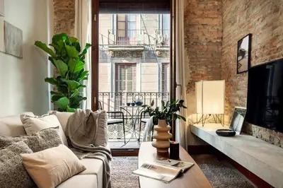 a living room with a couch and a window at Kasa - 2 bedrooms in Ciutat Vella in Barcelona